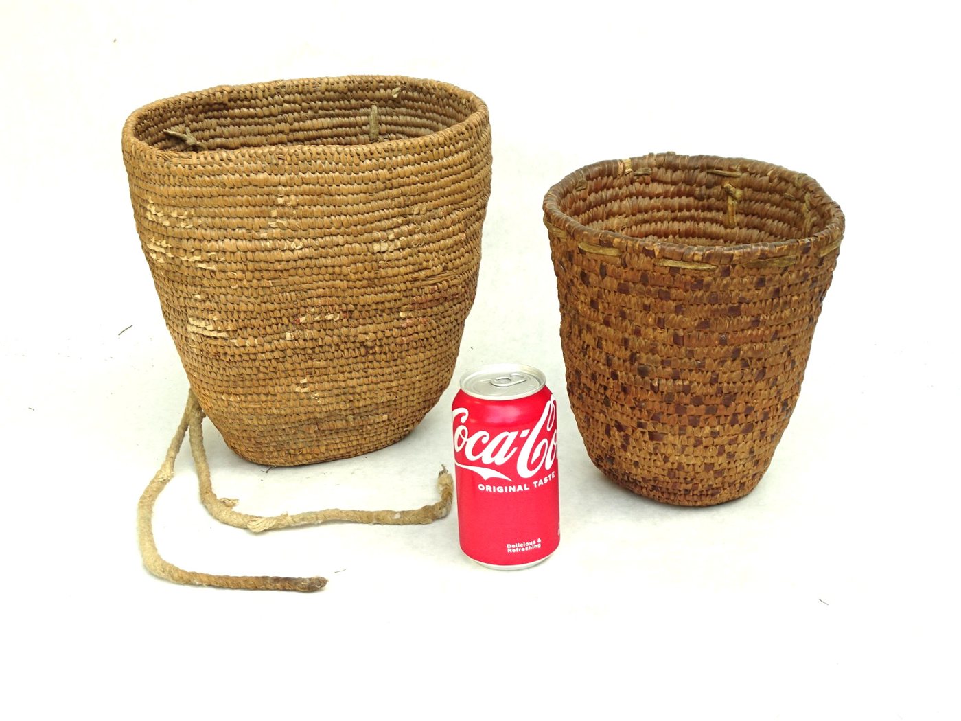 Two worn Plateau coiled cedar-root utility baskets