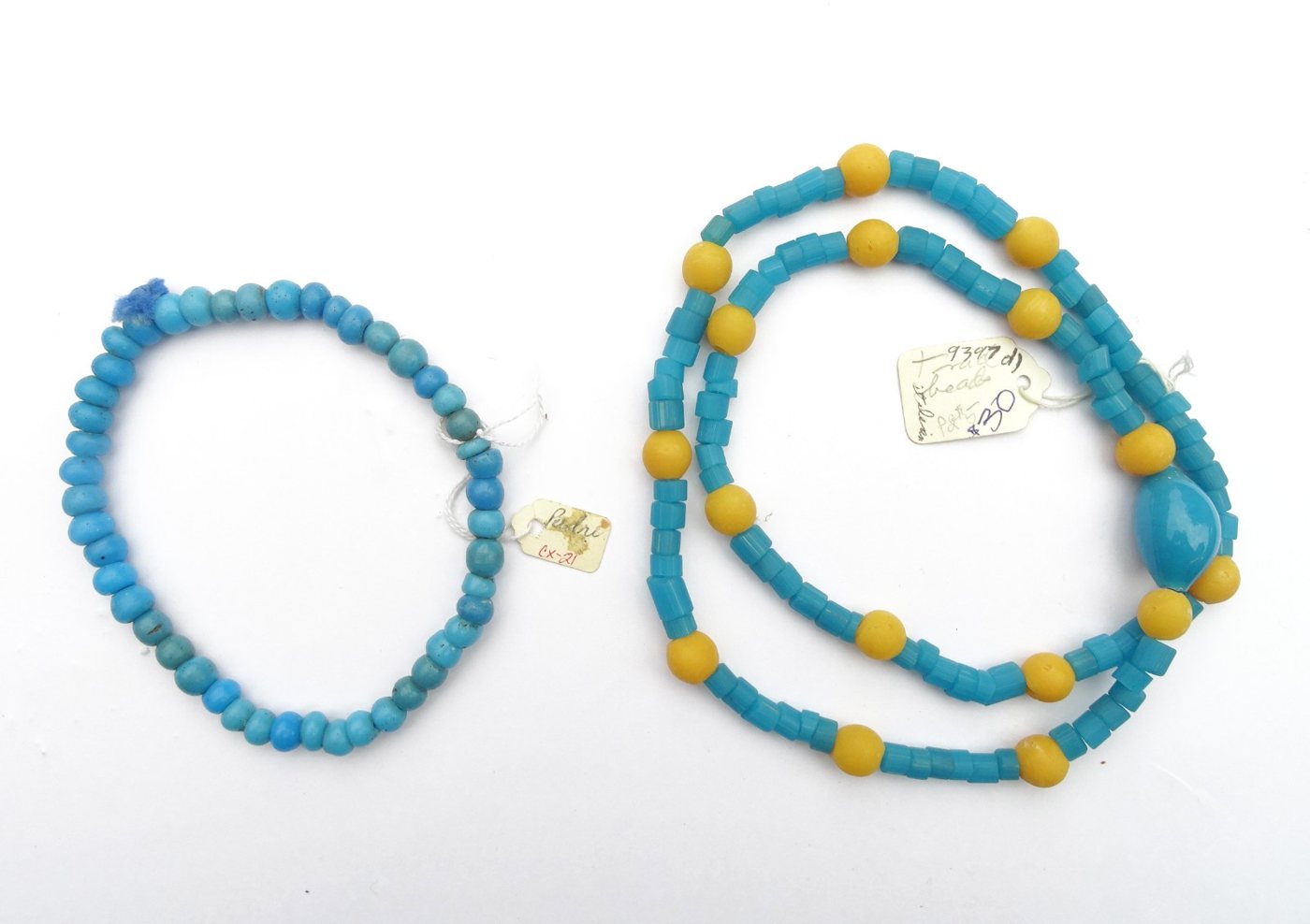 Two strands — blue padre beads and turquoise/yellow trade beads