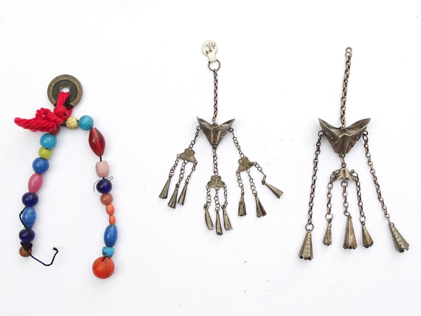 Two Chinese silver chatelaine pendants and a bead-and-coin charm string