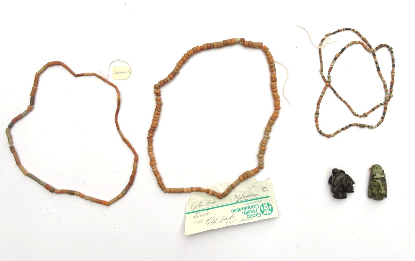 Three Sinú-type pottery bead strands with two carved stone face pendants