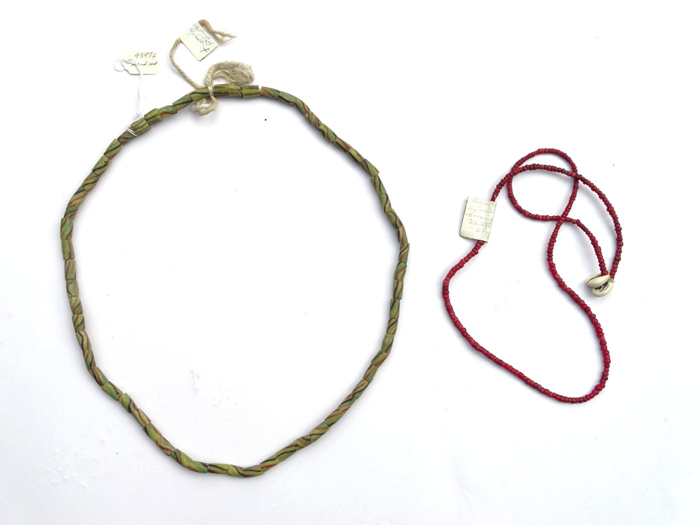 Two trade bead strands: striped powder-glass tubes and red white-hearts