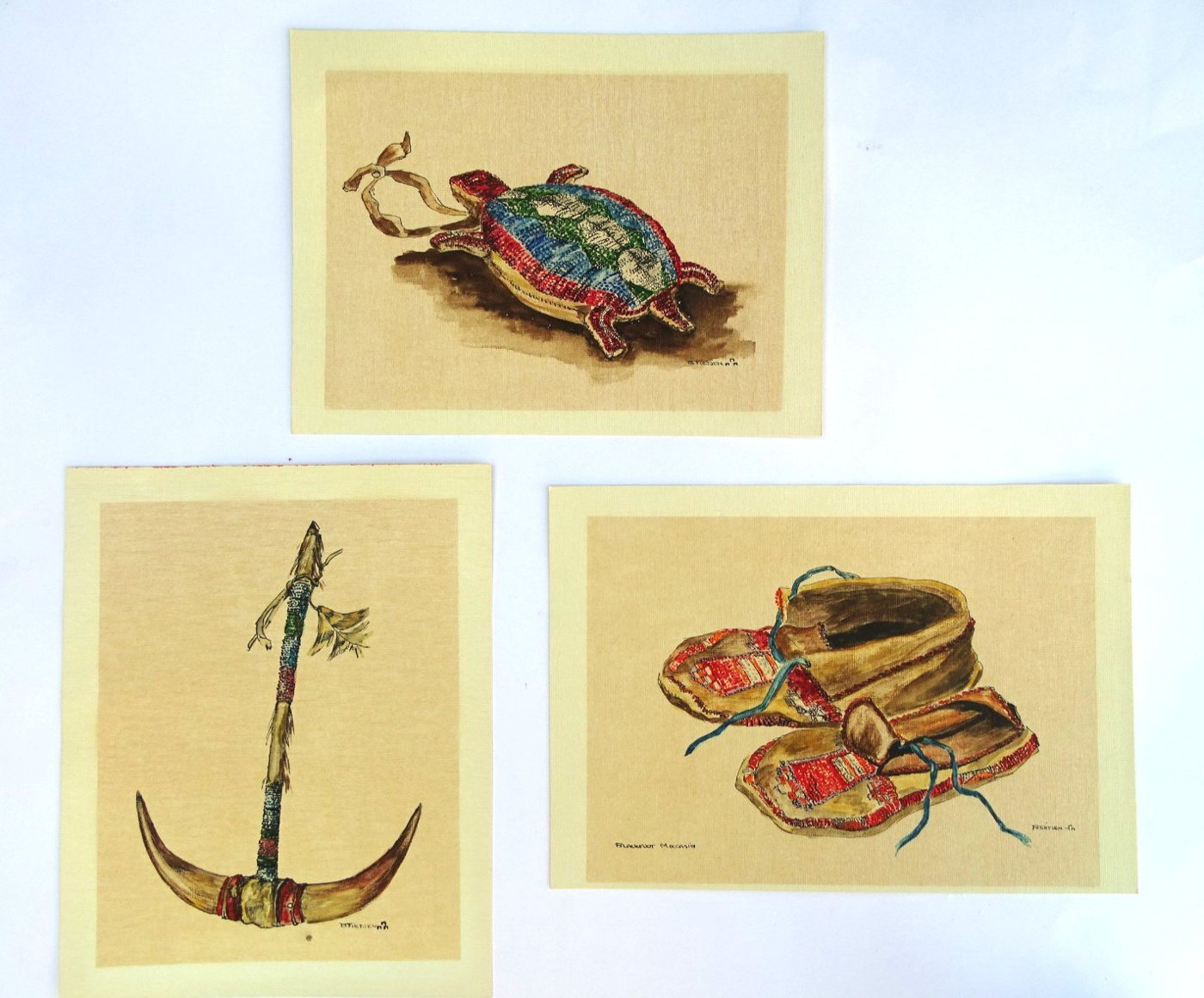 Three B. Tietjen Native artifact prints (turtle amulet, horn headdress, Blackfoot moccasins)
